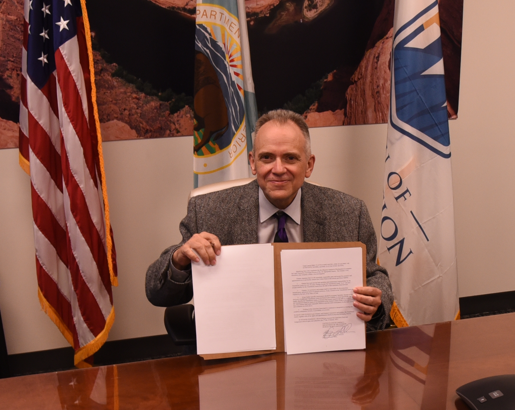 Regional Director Wayne Pullan signing Hyrum-Mendon Canal and Wellsville Canal title transfers