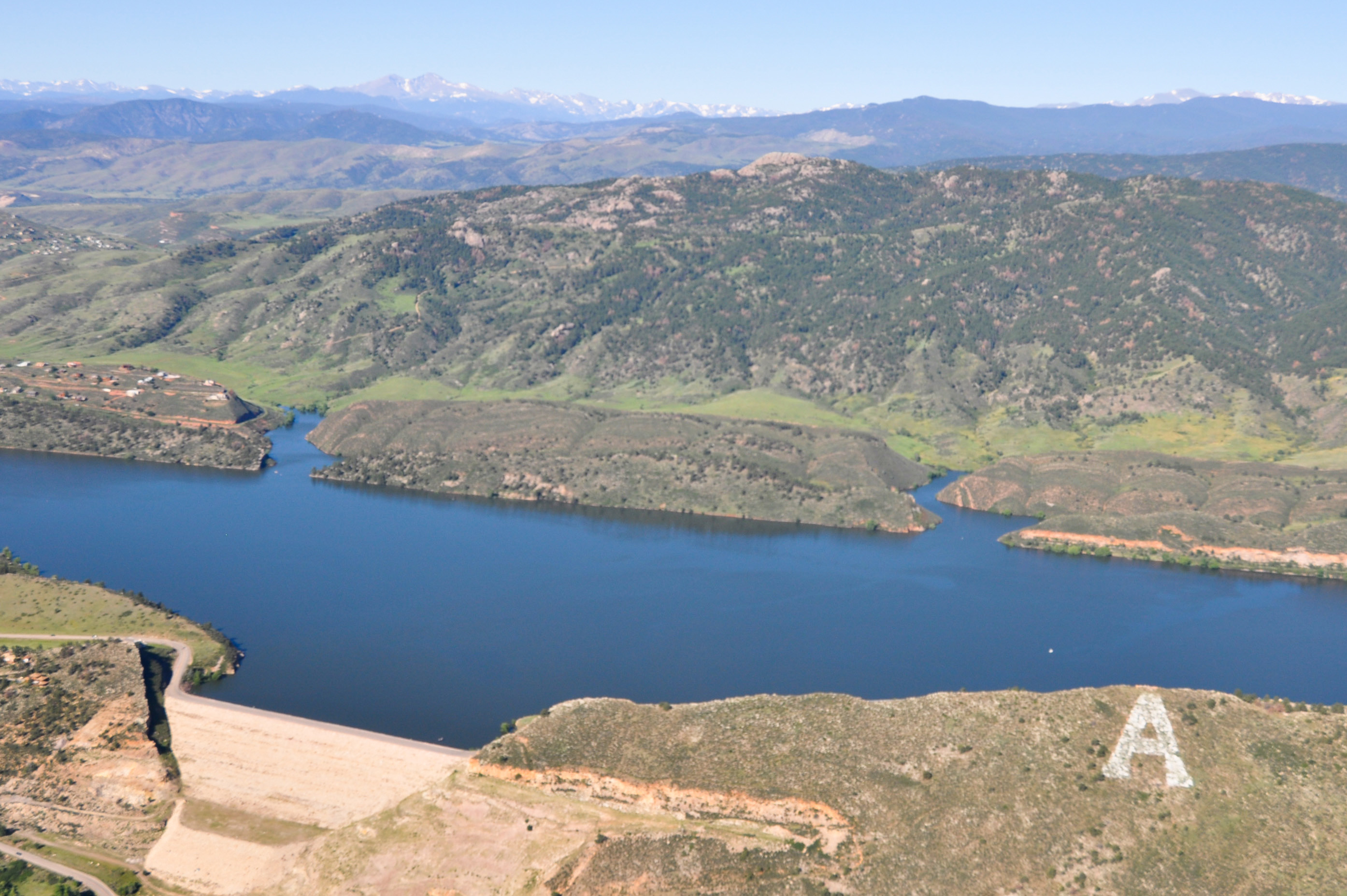 Carter Lake Reservoir and Dam during summer with boats.