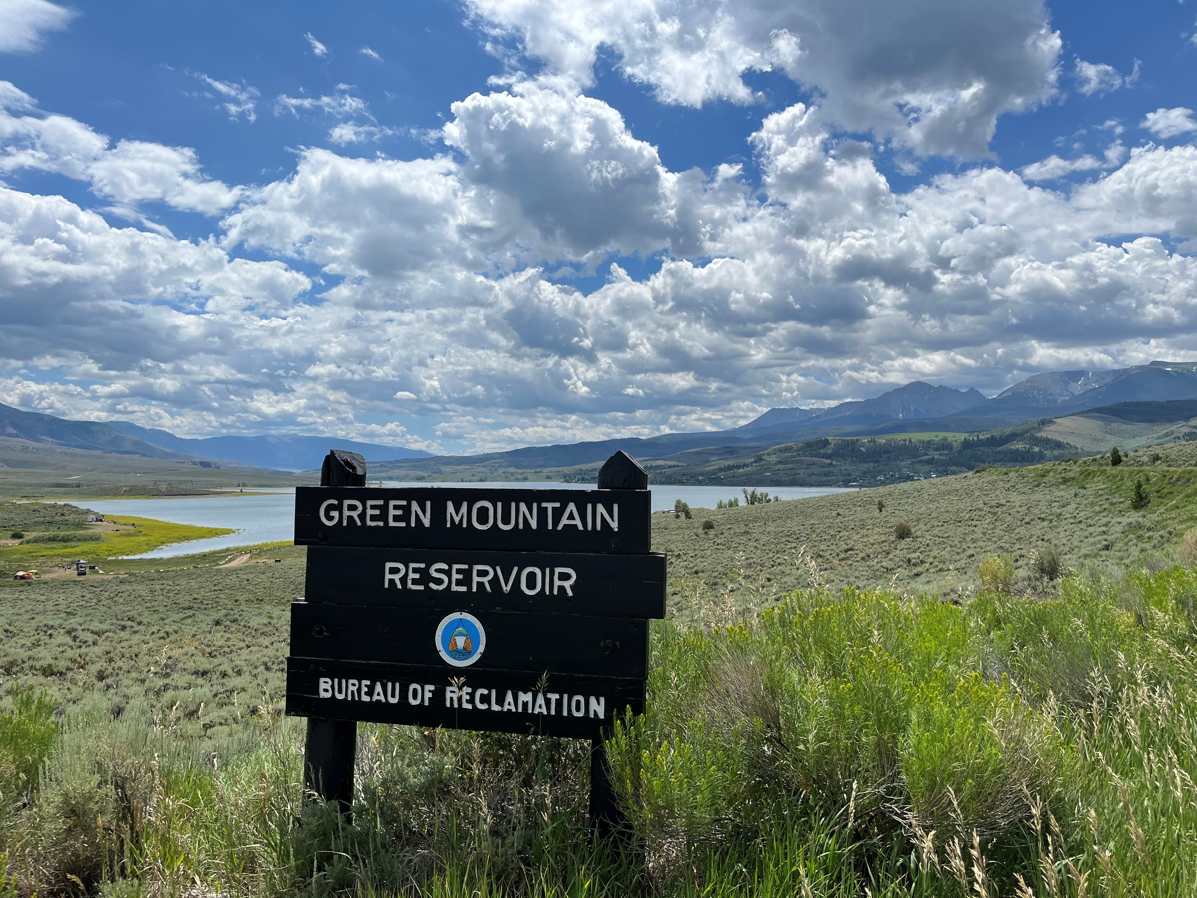 Green Mountain Reservoir with sky and puffy clouds in summer.