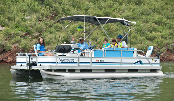 Photo of a family recreating on a pontoon boat.