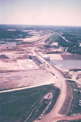 Aerial view of the spillway and maximum dam section facing east. Note the river diversion on the far side of the concrete spillway section. Photo April 8, 1980.