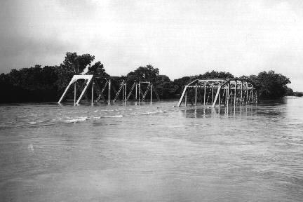 The Southern Pacific Railway and one U.S. Highway 59 bridge at the Navidad River near the dam site on June 15, 1973. The dam was built to limit future flood damage.