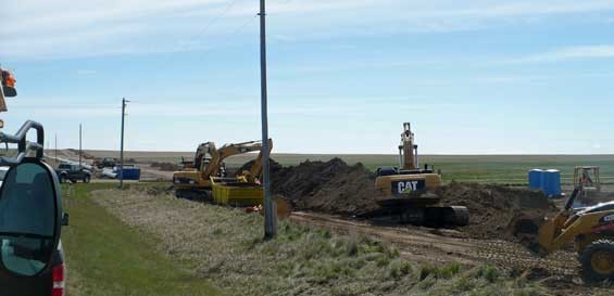 Photo of construction equipment and dirt mounds