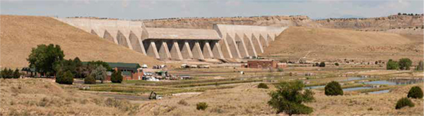 Pueblo Dam rises beyond Pueblo Fish Hatchery which was originally built as a part of the Fryingpan-Arkansas Project.