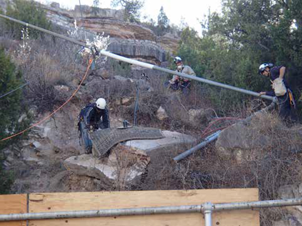(L to R) Nathan Harp, Bryan Nyffeler, and Mark Ronca, prepare a Bolder Buster Charge in a slab above the power plant.