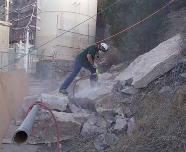 Bryan Nyffeler drills larger fragments for more blasting.