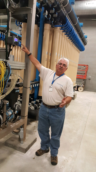 Tom Thompson inside the Standing Rock Rural Water Supply System water treatment plant explains the advanced water filtration system.
