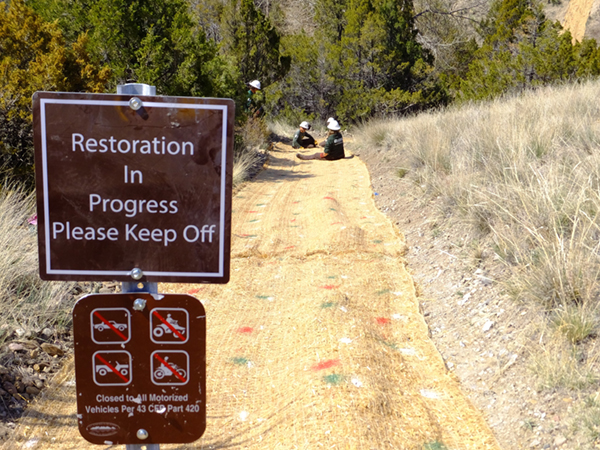 Signs are used to inform the public that restoration efforts are taking place.