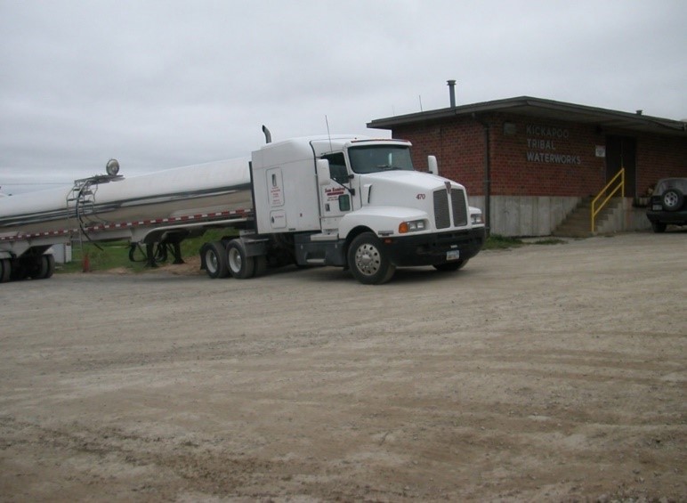 Photo of a semi truck and a building in the background