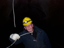 Green Mountain's Electrician Mark Stanfill deep in the Adams Tunnel under the Continental Divide working to fix a thermocouple device. Photo by Charles Young.