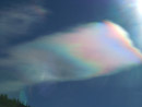 An ice-crystal cloud splits the sunlight like a prism.