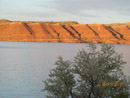 View of geological uplift bluffs across Alcova Reservoir looking East at sunset. Photo by Harold Morrow.