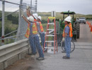 NKAO maintenance crew re-installing security fence after a spillway bridge inspection. Photo by Bernie McClellen.