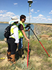 Ron Robertson teaching the Pathways Intern Marisela Castro how to set up the GPS for a topographical survey at Fresno Dam in Havre, Mont. Photo by Anellise Deters.