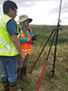 Ron Robertson teaching Anellise Deters how to set up the GPS to begin the topographical survey of Fresno Dam in Havre, Mont. Photo by Marisela Castro.