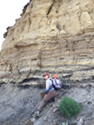 Laura J. Clarke, paleontologist, conducted a paleontology survey at Shadehill Reservoir, Perkins County, South Dakota in the summer of 2017. She examined a text book example of the K-Pg boundary (the black layer) that marks the Cretaceous-Paleogene extinction event that occurred about 66 million years ago. The event represents a mass extinction of plants and animals as a result of a major event impacting the environment. The Ludlow Formation lies above the and the Hell Creek Formation lies below the K-Pg boundary in this location.