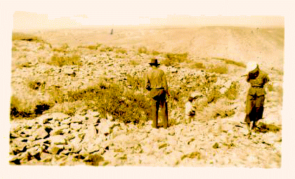 Two men and a woman looking through the quartzite quarries. Sepia tone photo.