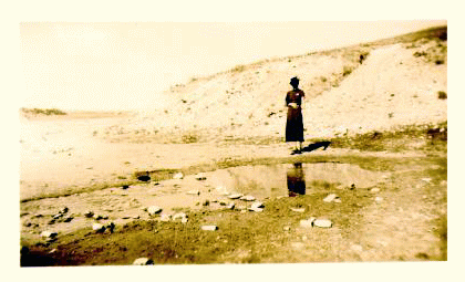 Woman standing near a warm spring  pool. Sepia tone photo