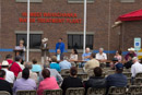 A view of the dedication ceremony with the water treatmant plant in the background.