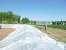 Construction of a berm to protect the Mni Wiconi Rural Water System raw water pump station. June 2011.