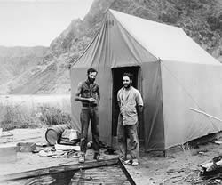 Photo of two men 'camping out'. 