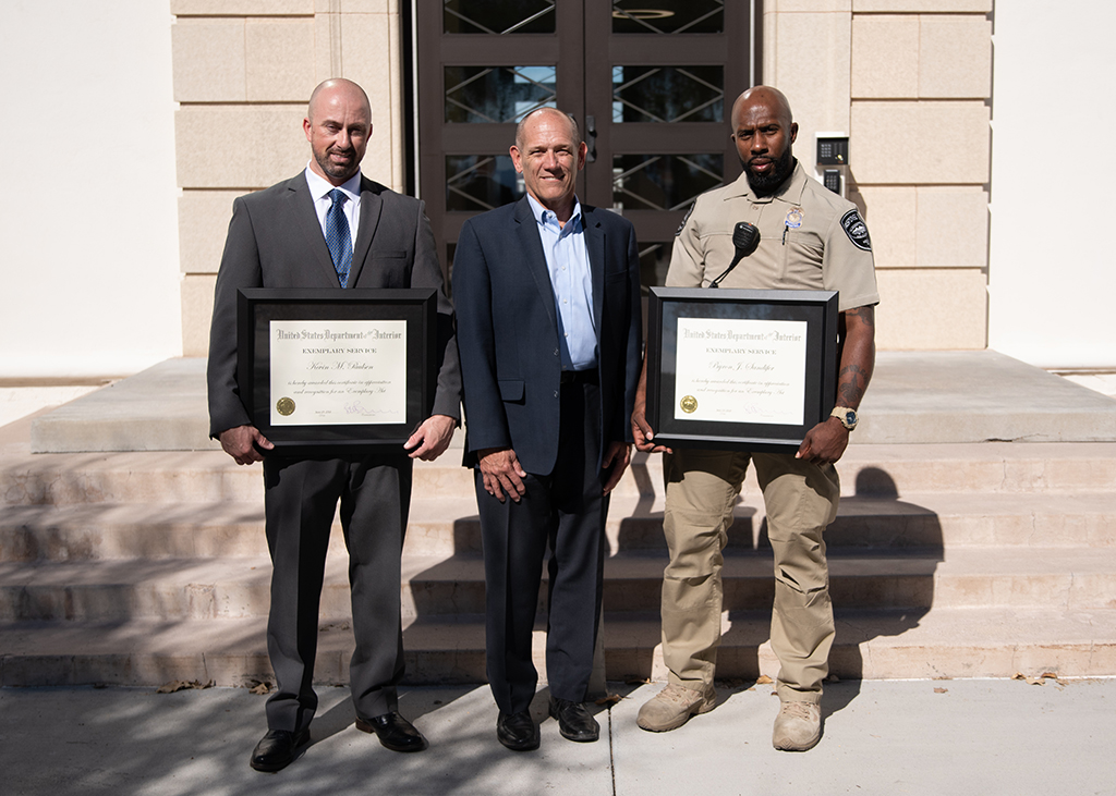 Pictured are security officers Kevin Paulsen (left) and Byron Sandifer (right) who were recognized by Regional Director Terry Fulp (center) for saving a man’s life.  