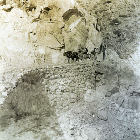 Apache workers were known for their skill in building dry-laid stone walls.  Without using mortar, they constructed many such retaining walls along the various roads they built.  This fine example is on Fish Creek Hill on the Mesa to Roosevelt Road, known today as the Apache Trail, 1905. (Courtesy of Salt River Project)