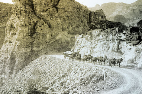 A portion of Mesa to Roosevelt Road at Fish Creek Hill.   Note the extensive road work required to cut through the mountain and provide fill for a stable road bed.  American Indians, primarily Apaches, constructed over 100 miles of roads to provide access for men, equipment, and supplies to the dam site, 1905. (Reclamation photograph)
