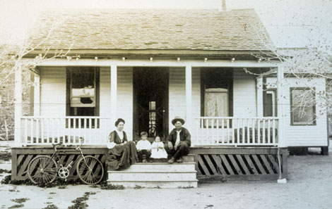 Luther Jackson and his family on the porch of their home, probably at Roosevelt. Luther was a ditch rider, most likely on the diversion canal that brought water to the generating plant.  He was responsible for seeing that the canal worked as planned and was properly maintained, 1909. (Reclamation photograph)