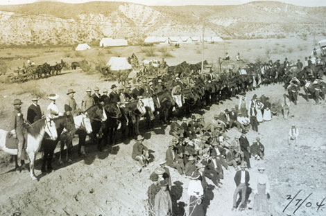 This 1904 photograph shows the dam builders assembled for a special event.  The supervisors and engineers are on horseback, while workers and some of their wives sit or stand. (Reclamation photograph)