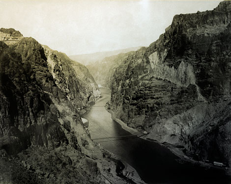 This photograph shows preliminary work on the Black Canyon site. Note portals to tunnels No.2, No. 3, and No. 4.  In the upper left, a retaining wall on the road to dam, can be seen. The dam site is located at the uppermost bridge crossing the river. (Reclamation photograph)