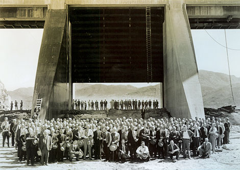 Reclamation and contractor personnel pose beneath one of three Stoney gates in this 1939 photograph.  Each Stoney gate  was 50 feet by 50 feet, weighed 200 tons, and could be raised about 4 inches per minute. (Courtesy of Salt River Project)