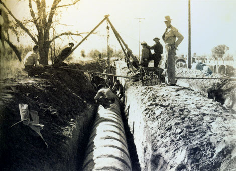 In this 1938 photo,  a CCC work crew from Camp BR-19 installs a 30-inch diameter pipe along a lateral known as 'Little Maricopa' west of Central Avenue in Phoenix. (Reclamation photograph)