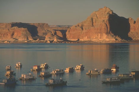 Houseboats on Lake Powell, the reservoir created by Glen Canyon Dam. In the 1960s, recreation became an authorized component of Reclamation projects. Reclamation ERA photo.