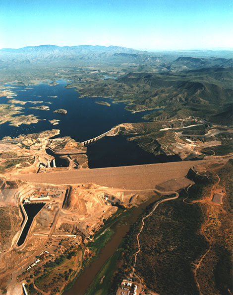 Construction of New Waddell Dam. Pump generating plant is to the left and the old Waddell Dam can be seen behind the new construction. (Reclamation photograph)