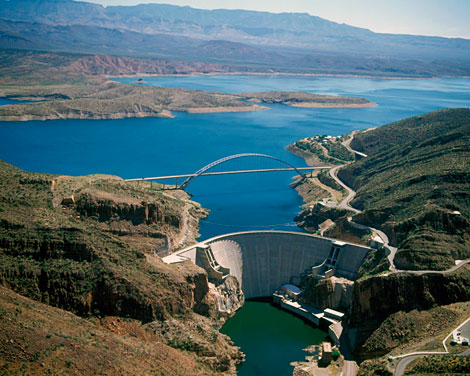 Roosevelt Dam received a 450,000 cubic yard concrete facelift. The new Roosevelt Lake Bridge is in the background. (Reclamation photograph)