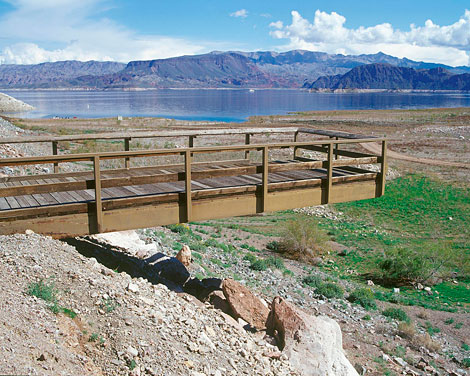 A once popular fishing pier stretches over dry land far from the water's edge at Lake Mead. (Reclamation photograph)
