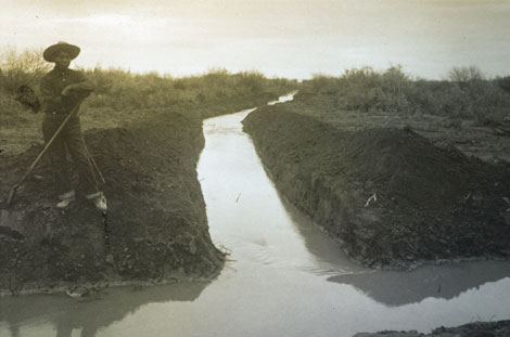 A Pima man in Sacaton works on an irrigation canal.  Tribal water rights issues in Arizona date back to the earliest days of settlement by Anglo Americans. (Reclamation photograph)