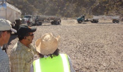 Environmental Awareness Specialist Phil Aurit, left, and Realty Specialist Jason Kirby, right, speak with Adolfo Torres