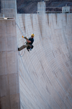Corey Dickson begins a descent on the face of Hoover Dam.