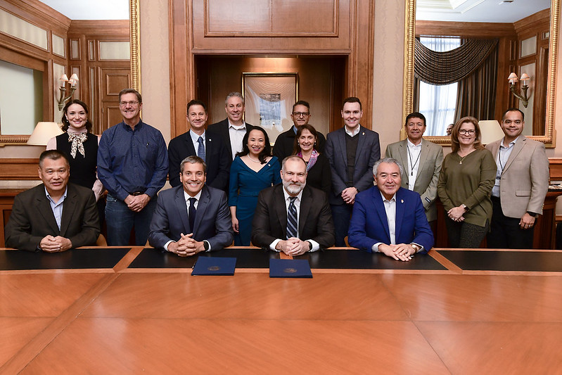 Reclamation staff and California Water Leaders stand together behind a table.