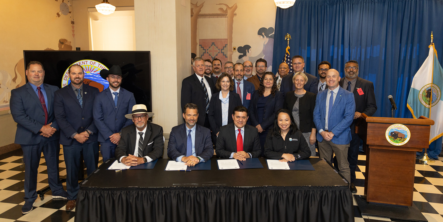 A group photo of people behind a table.