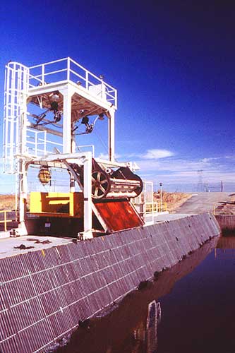 photograph: Looking north at the trash rack on the intake channel of the Tracy Fish Collection Facility, Tracy, California. Reclamation photo by Doug Craft