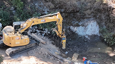 Dam removal using a hydraulic hoe ram, looking from the right bank