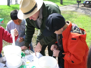photograph of Ranger with Kids and Invertebrates; click for larger photo