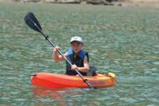 non-interactive image of child on a kayak