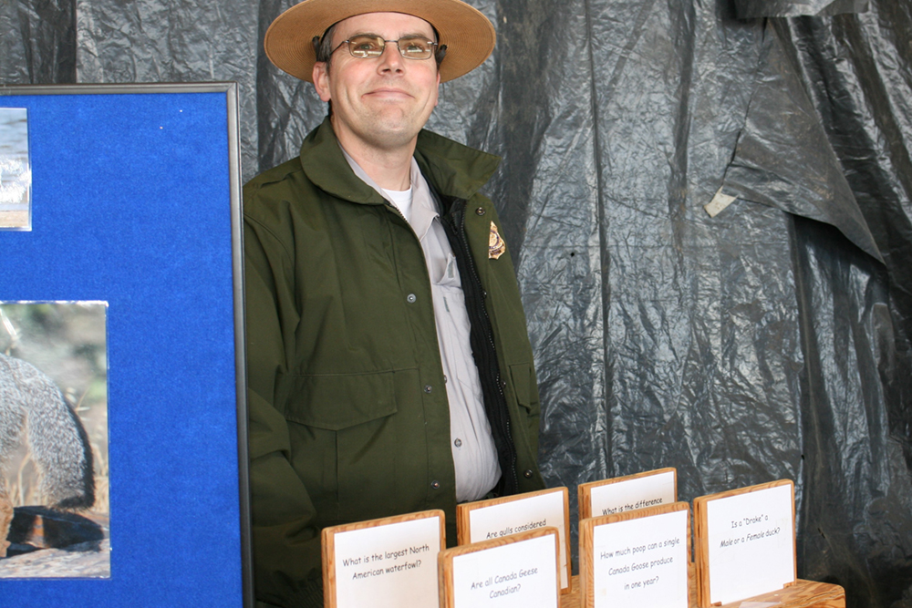 Park Ranger Todd Eggert poses by Reclamation's California Duck Days exhibit.