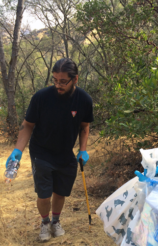 Volunteer finding trash along trail to Markley Cove.