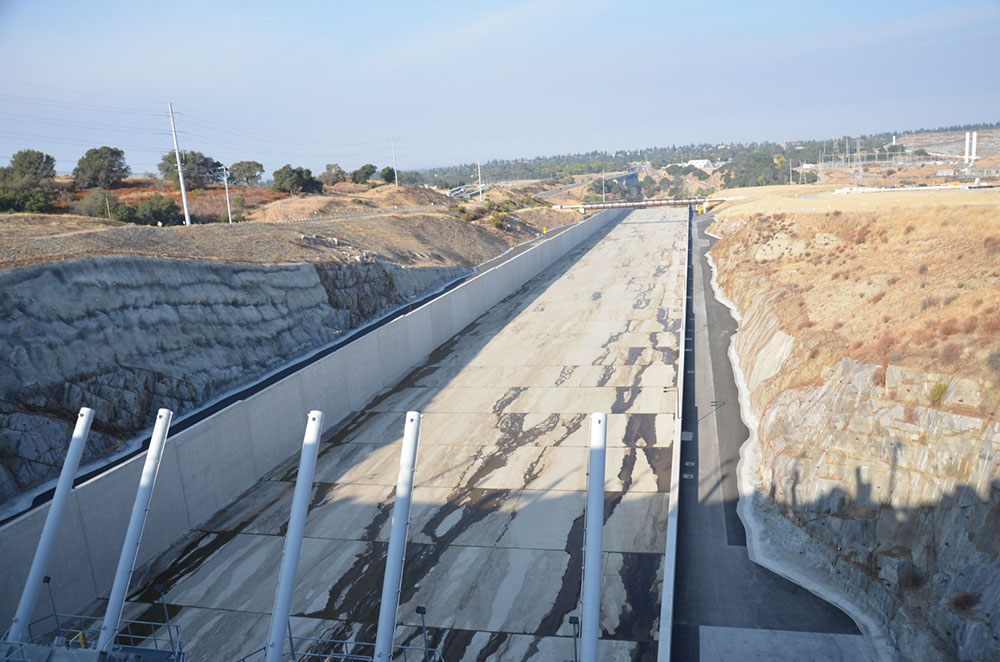 A downstream view from atop the control structure of Folsom Dam’s new auxiliary spillway Oct. 17, 2017. (Reclamation photo by Winetta Owens)