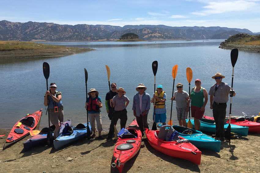 Visitors pose with kayaks before event